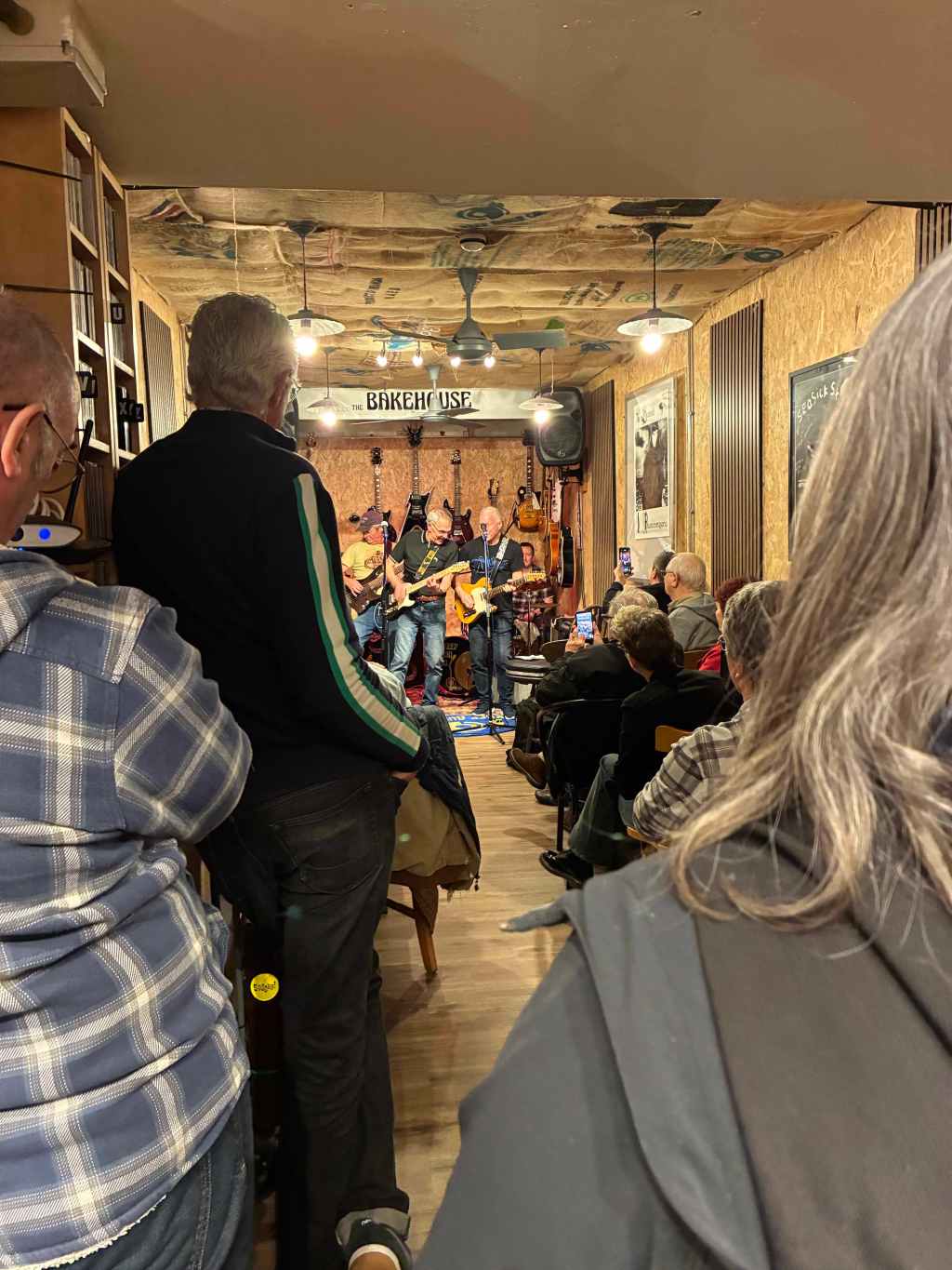 Musicians playing blues guitar and generally being cool in a crowded cafe space at Keep Audio Co. in Launvceston.