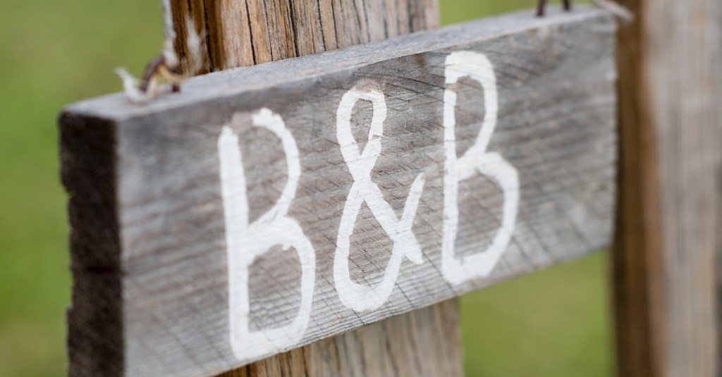 B&B sign on old wooden plaque